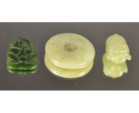 A carved jade Buddha head bead; a dish roundel; a nephrite monkey pendant (3)
