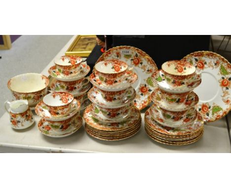 An Edwardian tea service decorated in the Imari palette, comprising side plates, cups and saucers, slop bowl, cream; etc. 