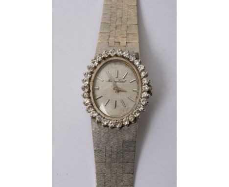 A lady's 18ct white gold Tissot watch "Mathey" with a diamond studied bezel , working order 