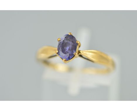 A 9CT GOLD TANZANITE RING, the oval tanzanite within a six claw setting to the tapered shoulders, 9ct hallmark for Birmingham