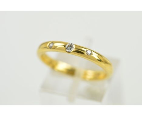 A MODERN 18CT GOLD DIAMOND SET BAND, three modern round brilliant cut diamonds totalling 0.10ct, band measuring 3mm in diamet