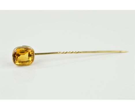 A GOLD AND CITRINE STICK PIN, centring on a cushion cut citrine measuring approximately 13.7mm x 12mm, approximate gross weig