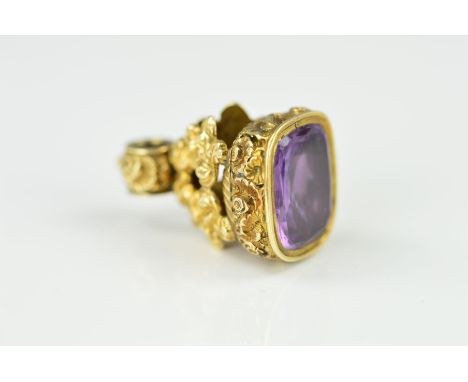 A MID VICTORIAN AMETHYST SEAL, the grip with floral and foliate decoration set with a rectangular amethyst seal, length 28mm