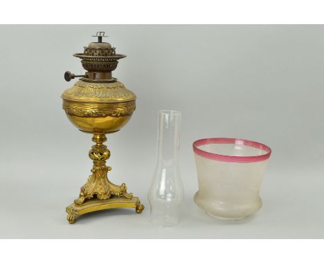 A BRASS OIL LAMP, on trefoil base, with glass funnel and etched shade, approximate height base 42cm