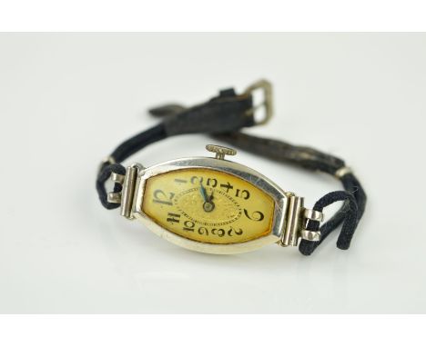 AN ART DECO 18CT GOLD COCKTAIL WATCH, the tonneau shape head with white dial, Arabic numerals and central engraved floral det