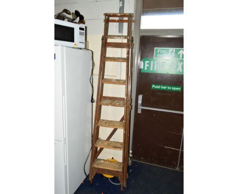 A TALL WOODEN STEP LADDER