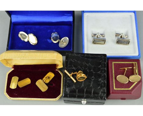 A CUFFLINK AND TIE PIN COLLECTION to include a late 20th Century 9ct gold pair of oval cufflinks, diamond cut design, hallmar