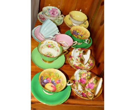 A SMALL GROUP OF CABINET CUPS AND SAUCERS, to include Royal Chelsea 'Golden Rose', Aynsley 'Orchid Gold' signed D Jones, Shel