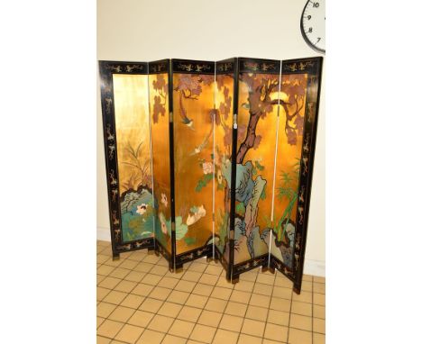 A 20TH CENTURY JAPANESE BYOBU SIX FOLD DOUBLE SIDED SCREEN, gilt and ebonised ground, the panels making a scene of floral and