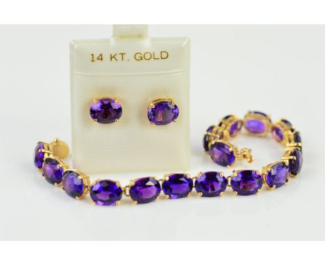 AN AMETHYST BRACELET AND EARRINGS, the bracelet designed as oval amethysts links, within four claw settings to the push piece