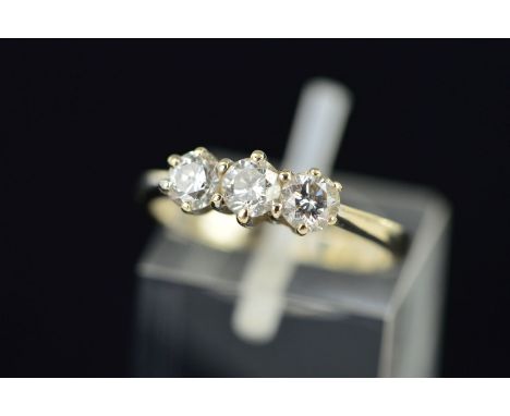 AN 18CT WHITE GOLD THREE STONE DIAMOND RING designed as three brilliant cut diamonds within claw settings, 18ct hallmark for 