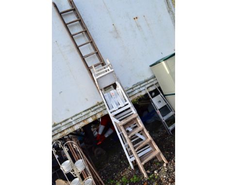 A COLLECTION OF WOODEN LADDERS, comprising of a set of double extension ladders, two medium painted white step ladders and a 