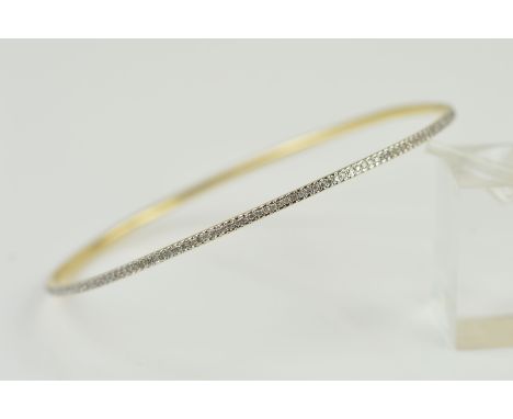 A DIAMOND BANGLE, the thin bangle pave set with single cut diamonds, stamped diamond weight 0.56ct, diameter 63mm, 6 grams