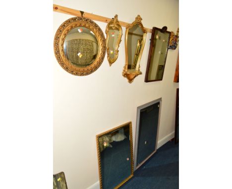 A LATE 19TH CENTURY ROSEWOOD FRAMED WALL MIRROR, a modern gilt wall mirror/shelf, a circular convex wall mirror and three oth