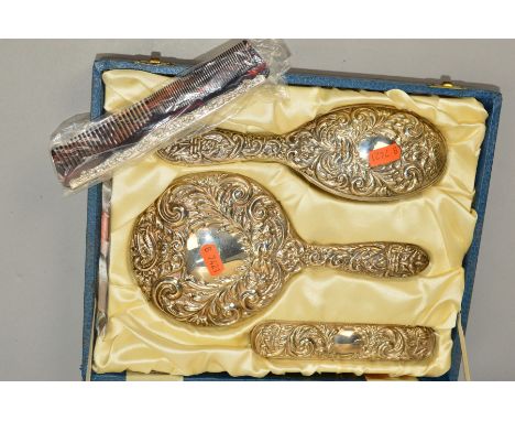 AN ELIZABETH II CASED SILVER FOUR PIECE DRESSING TABLE SET, comprising hand mirror, two brushes and a comb, maker B&amp;Co, B