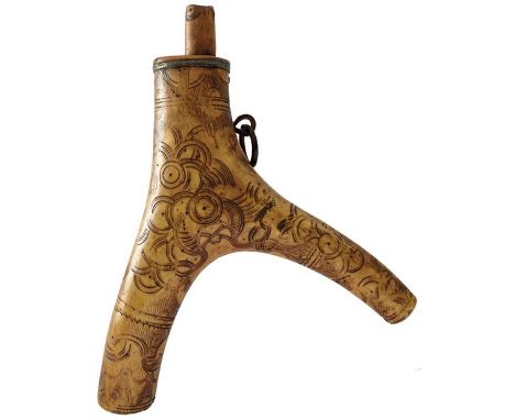 A 17TH CENTURY GERMAN POWDER FLASK, the two-branch stag horn body decorated with panels of geometric circular designs in the 