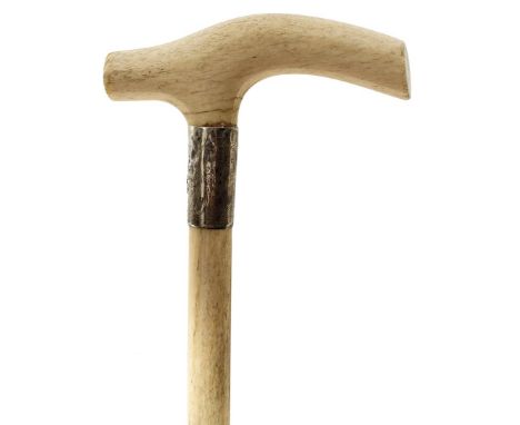 AN EARLY 20TH CENTURY WALKING STICK, the whole of marine ivory, the handle of plain form above silver collar hallmarked Londo