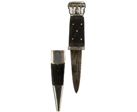 A WHITE METAL MOUNTED SGIAN-DUBH, 8cm fullered blade with faceted back edge, patinated, carved basket weave grip, set with wh