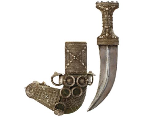 A WHITE METAL MOUNTED JAMBIYA, 20cm sharply curved blade with raised medial ridge, characteristic white metal hilt with filig