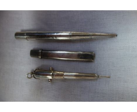 A SILVER PROPELLING PENCIL in the form of a cannon, a similar propelling pencil and a silver covered pencil (3)