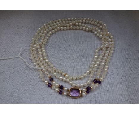 A DOUBLE STRAND CULTURED PEARL NECKLACE with amethyst clasp