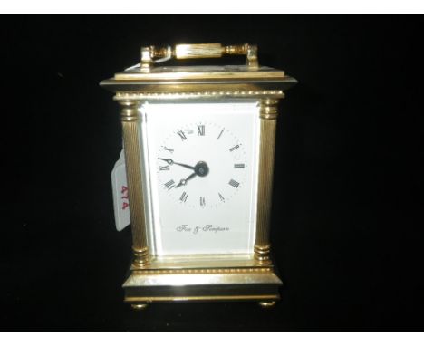 A BRASS CASED CARRIAGE CLOCK by Fox &amp; Simpson, 13cm high