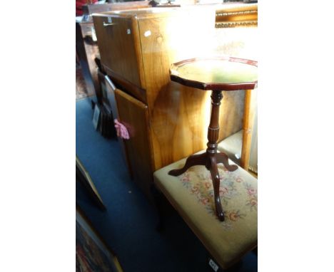 A VINTAGE WALNUT COCKTAIL CABINET, 57cm wide, a wine table, a mirror, a print and a stool