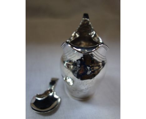 A GEORGE III SILVER CREAM JUG and a silver caddy spoon (2) 100g (approx)