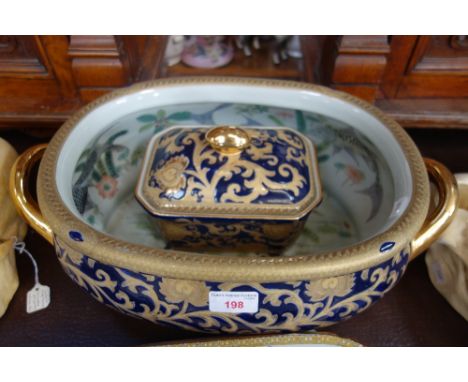 A CHINESE OVAL BOWL decorated with gilt and enamel, the interior painted with fish, 44cm wide and a matching octagonal covere