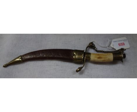 A HORN HANDLED DAGGER with brass mounts and leather scabbard