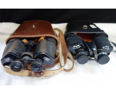 A PAIR OF VINTAGE BINOCULARS, in a fitted brown leather case, together with one other similar pair (2)