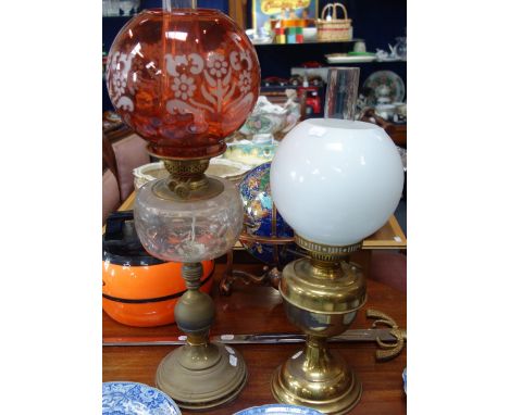 A VICTORIAN OIL LAMP with an etched pink shade and another oil lamp