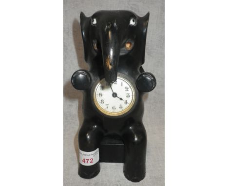 AN EARLY 20TH CENTURY WOODEN MANTEL CLOCK in the from of an elephant, 21.5cm high