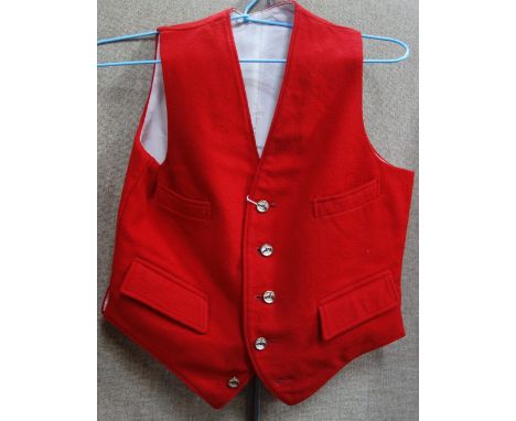 A CHILD'S RED WOOL HUNTING WAIST COAT, fastened to the front with five matching buttons depicting horses' heads and a collect
