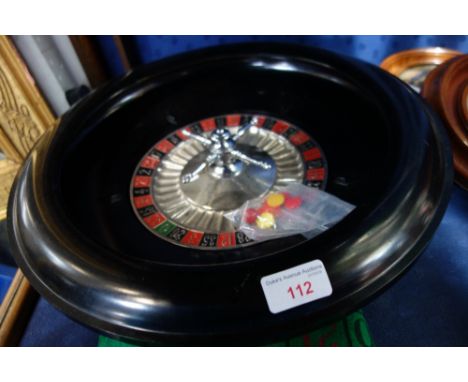 CHAD VALLEY; A VINTAGE BLACK BAKELITE ROULETTE WHEEL, 19cm dia and a green baize gaming mat with counters