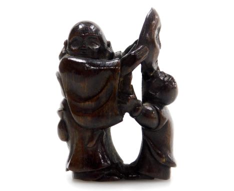 A contemporary Japanese style  hardwood netsuke, carved as a father and son holding a noh mask, 4.5cm high. .