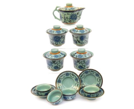 A modern Chinese pottery part tea service, decorated in blue and white with peonies against a pale blue ground, comprising a 
