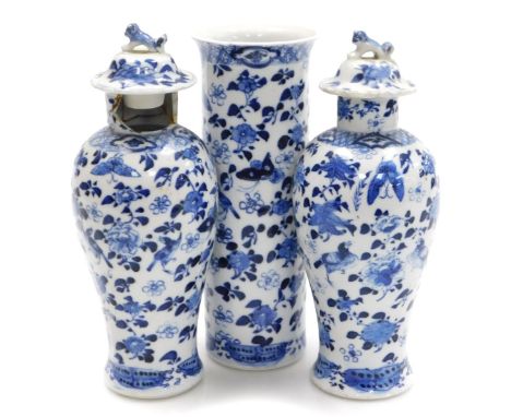 A garniture of Kangxi style porcelain blue and white vases, decorated with birds, flowers and butterflies, comprising a pair 