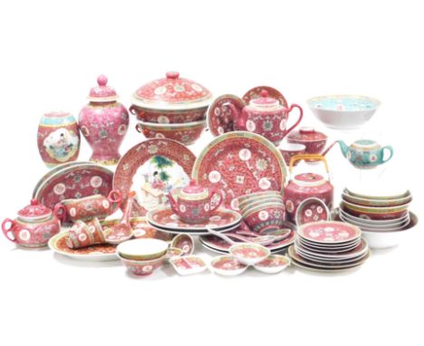 A Chinese red ground Mun Shou longevity dinner and tea service, including plates and bowls, teapots, sucrier, cream jug, ture