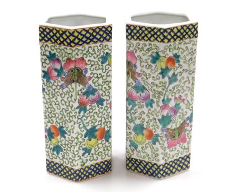 A pair of Chinese famille rose porcelain vases, of hexagonal form, decorated with butterflies, fruit and scrolling leaves, wi