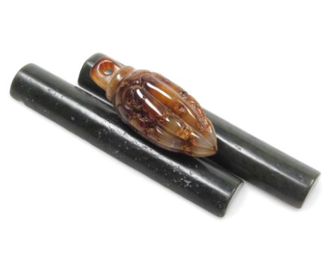 A pair of spinach jade wrist rests, probably Chinese, 18.5cm long, together with a fluted hardstone pull, 10.5cm high.