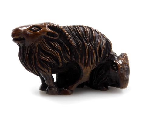 A contemporary Japanese hardwood netsuke, carved as two rams, signed, 4.5cm wide.