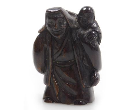 A contemporary Japanese style hardwood netsuke, carved as an elderly man with a boy upon his shoulder, 5cm high. 