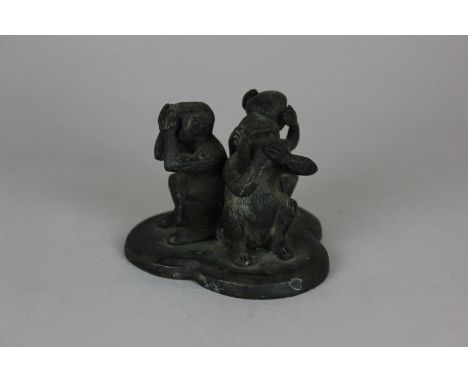 A bronzed metal model of 'see no evil, hear no evil, speak no evil' three wise monkeys, 6cm high