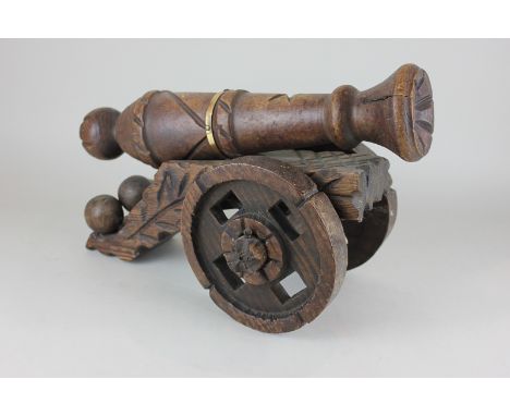 A Spanish olive wood model of a cannon, 42cm wide