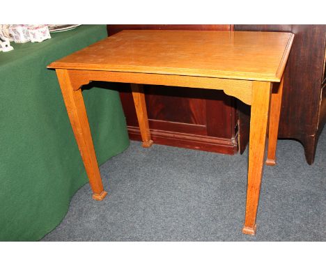 A light oak mid 20th century rectangular occasional table on straight tapered legs on square feet, 92cm by 60cm