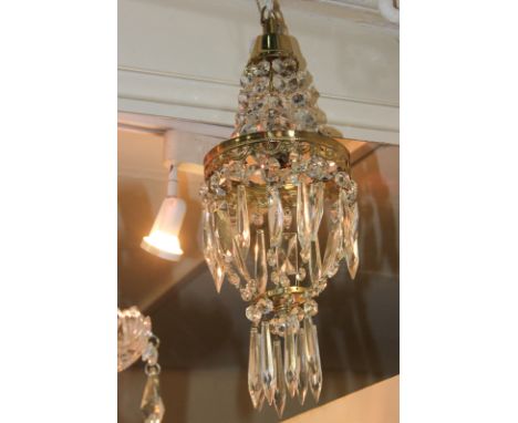 A three-tier brass and glass chandelier light fitting with teardrop shape droplets, 25cm