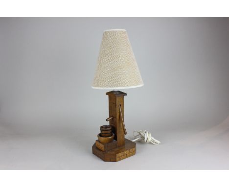 An oak table lamp modelled as a water pump, 28cm high