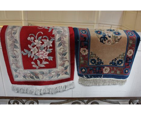 A Chinese rug, cream floral on red ground, 63cm by 125cm, together with another Chinese rug in blue, beige and red, 61cm by 9