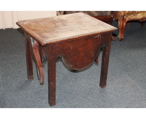 An early 20th century mahogany commode with lift-up flap top which becomes the back support, with two arms, with cream cerami